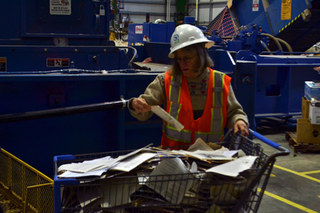 Alys finds something interesting to read in the shredded cart